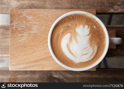 A cup of coffee put on wooden board with copy space to write. Classic chrome and vintage stlye.