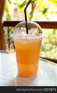 A cup of fresh orange juice with soda. fresh orange juice