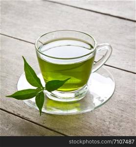 a cup of green tea on wood board, drink for health