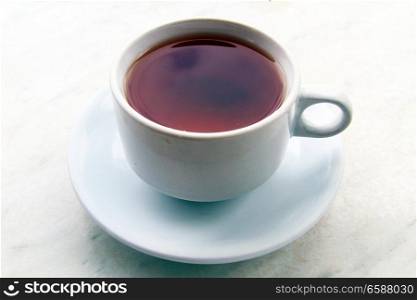 A cup of hot black tea on the table