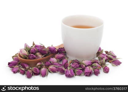 A cup of rose tea with dried rose flower on white background