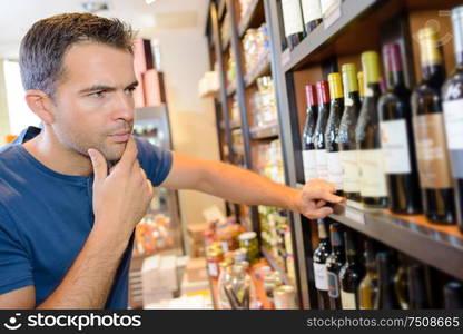 a customer reading a wine label