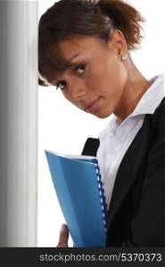 A cute black businesswoman holding a file.