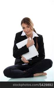 A cute businesswoman hugging a file.