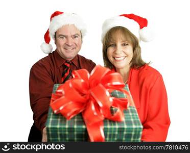 A cute couple with a Christmas gift for you. Isolated on white. (focus on the woman)
