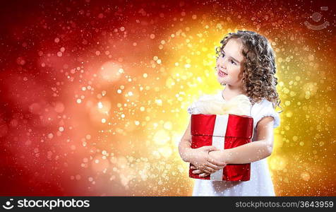 A cute young girl holding a christmas gift, dark background with christmas light bokeh