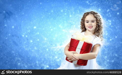 A cute young girl holding a christmas gift, dark background with christmas light bokeh