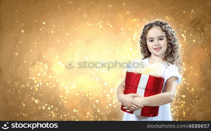 A cute young girl holding a christmas gift, dark background with christmas light bokeh