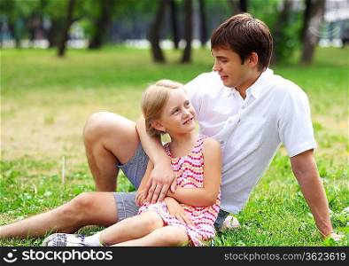 A dad and his daughter are together in the park