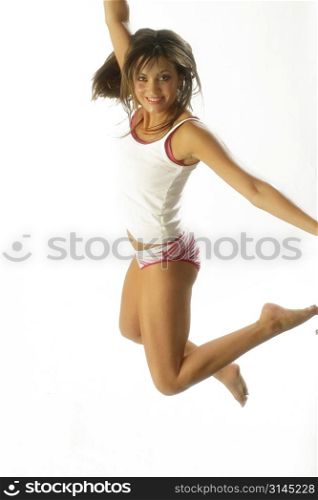 A dancer jumps into the air against a white backdrop.
