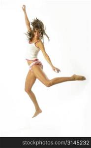 A dancer jumps into the air against a white backdrop.
