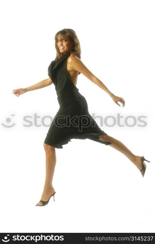 A dancer jumps into the air against a white backdrop.