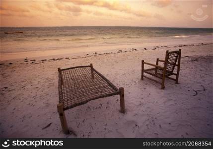 a deck Chair at a Restaurant and Guesthouse on the Beach with the Landscape at the East Coast at the Village of Bwejuu on the Island of Zanzibar in Tanzania. Tanzania, Zanzibar, Bwejuu, October, 2004