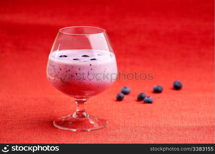A delicious blueberry smoothie on a red background