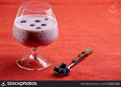 A delicious blueberry smoothie over a red cloth background