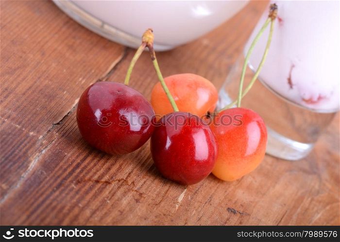 a delicious cherry milkshake on wooden plate