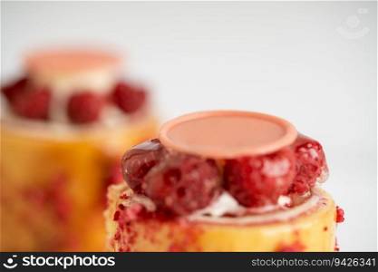 A delicious dessert of raspberry pudding topped with luscious cream and a sweet drizzle. The raspberry pudding is topped with cream and drizzle
