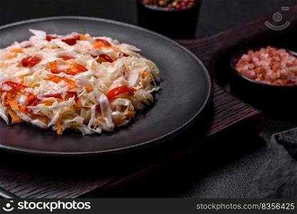 A delicious fresh vegetarian salad of white cabbage, carrot and paprika with olive oil. Healthy food. A delicious fresh vegetarian salad of white cabbage, carrot and paprika