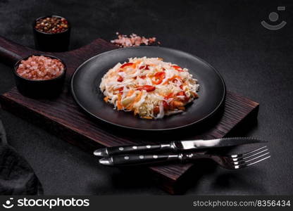 A delicious fresh vegetarian salad of white cabbage, carrot and paprika with olive oil. Healthy food. A delicious fresh vegetarian salad of white cabbage, carrot and paprika