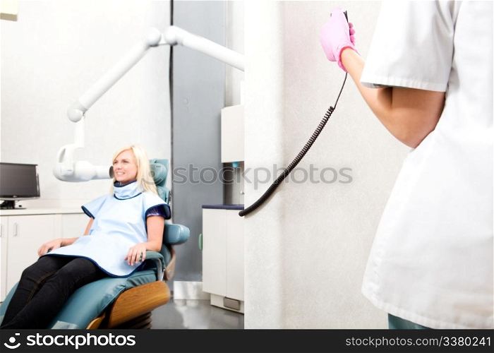 A dentist taking an x-ray of a patient