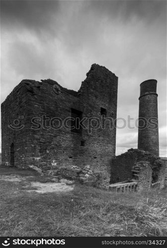 A derelict building and a chimney at a disused mine, Magpie Mine, in the Peak District