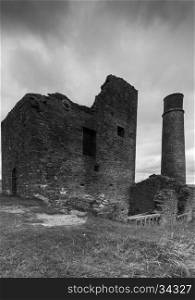 A derelict building and a chimney at a disused mine, Magpie Mine, in the Peak District