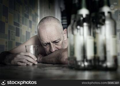 A desperate man falls into depression and becomes alcoholic and miserable. His addiction leads him to a state of loneliness and poverty. He has no hope and could be suicidal.