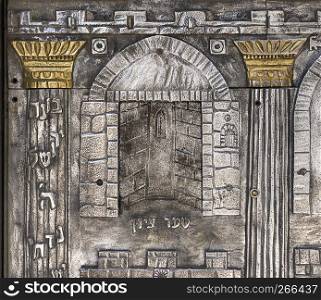 A detail from a panel on a door to the entrance of a synagogue shows an entrance to an old temple in the Old City of Jerusalem in Israel.