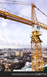A detail of a crane overlooking the Oslo fjord and city of Oslo.