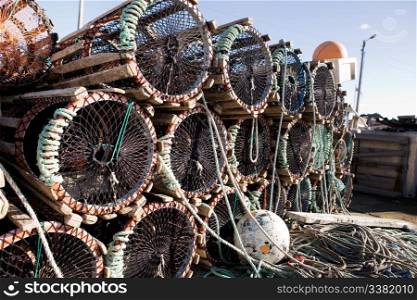 A detail of lobster traps stacked on the dock