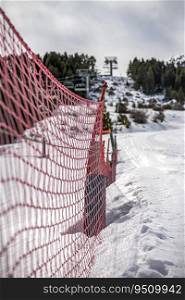 A Detail of orange plastic barrier on ski slope