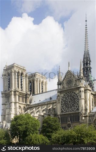 A detail of the Notre Dame, Paris, France with the sunlight striking the towers of this majestic cathedral and tourist attraction. The famous landmark is located on Ile de La CitZ