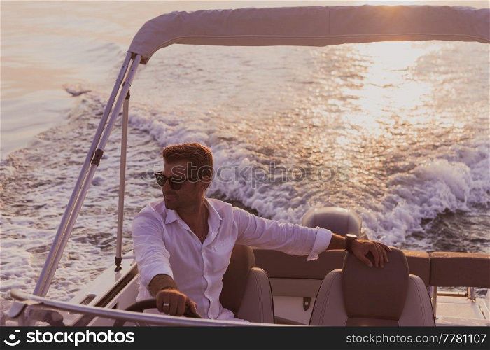 A determined senior businessman in casual clothes and sunglasses enjoys his vacation driving a luxury boat at sunset. Selective focus. High-quality photo. A determined senior businessman in casual clothes and sunglasses enjoys his vacation driving a luxury boat at sunset. Selective focus 