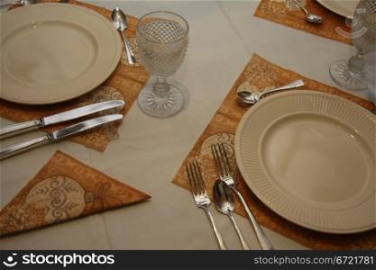 A dining table set for dinner with contemporary crockery and tableware