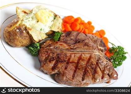 A dinner of a T-bone or porterhouse steak, served with baked potato with creamed parsley potato filling and boiled carrots, garnished with English parsley