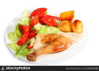 A dinner of roast chicken leg with salad and roasted potatoes