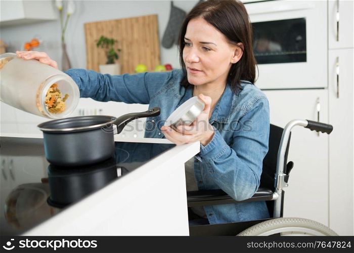 a disable woman cooking past
