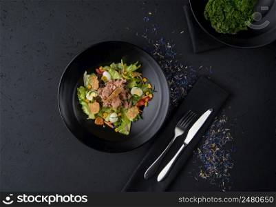 a dish of boiled meat on a black wooden surface, top view. a meat dish on a black surface