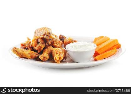 A dish of chicken hot wings and carrots with dipping sauce