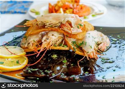 a dish of grilled shrimps with spice and lemon. a dish of grilled shrimps with spice