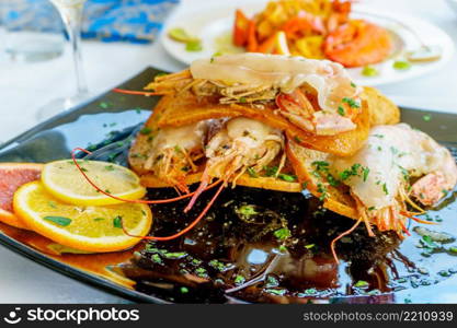 a dish of grilled shrimps with spice and lemon. a dish of grilled shrimps with spice