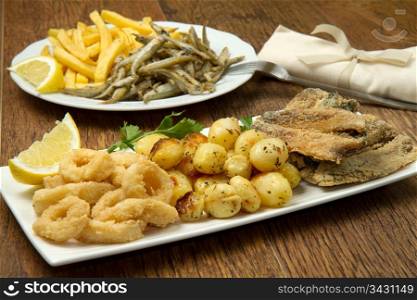 a dish with different fish fried and potate