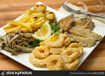 a dish with different fish fried and potate