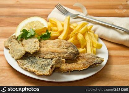 a dish with sardines fried and potate
