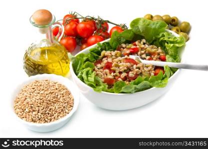 a dish with spelt salad with tomatoes,olive and salad