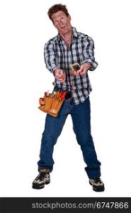 A disoriented man holding a multimeter