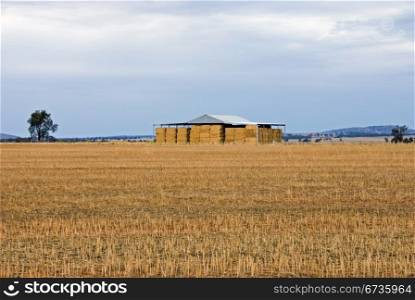 A distant hay shed on a remote farm in South-West New South Wales, Australia