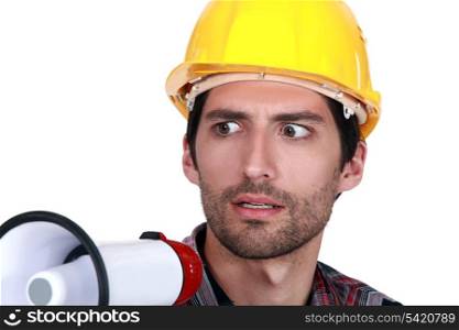 A disturbed tradesman holding a megaphone