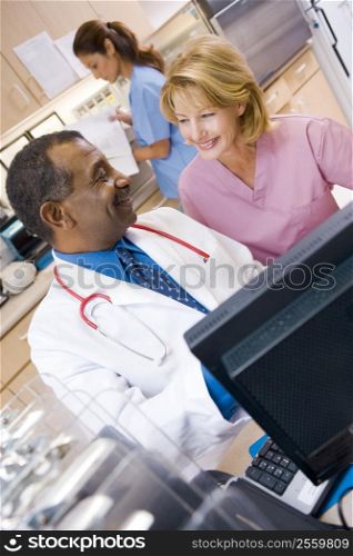 A Doctor And Nurse Discussing Something At The Reception Area Of A Hospital
