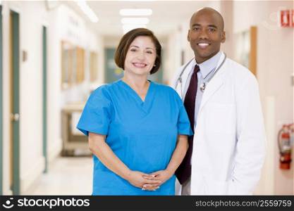 A Doctor And Nurse Standing In A Hospital Corridor